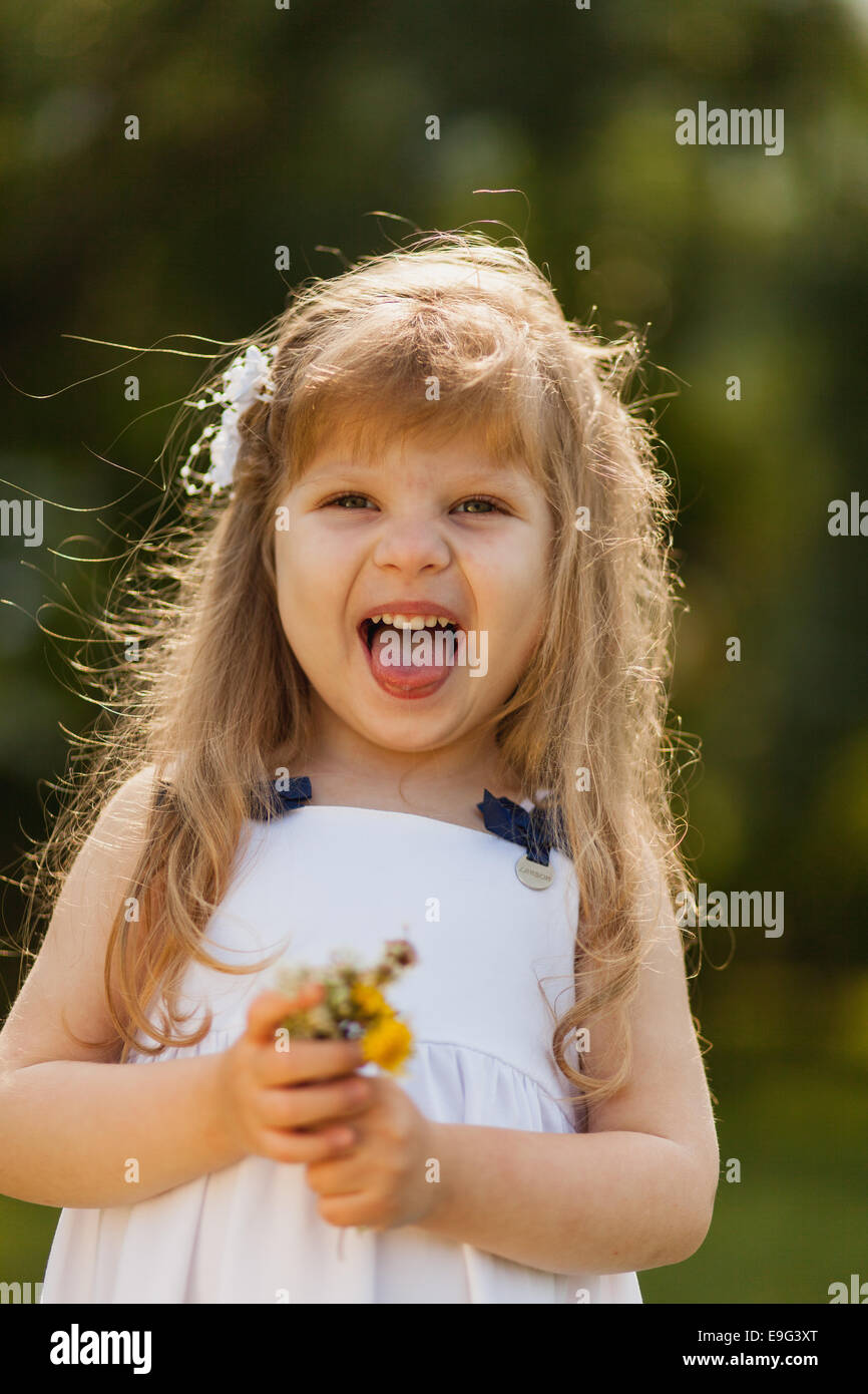 Girl with sunflower in summer field Stock Photo - Alamy