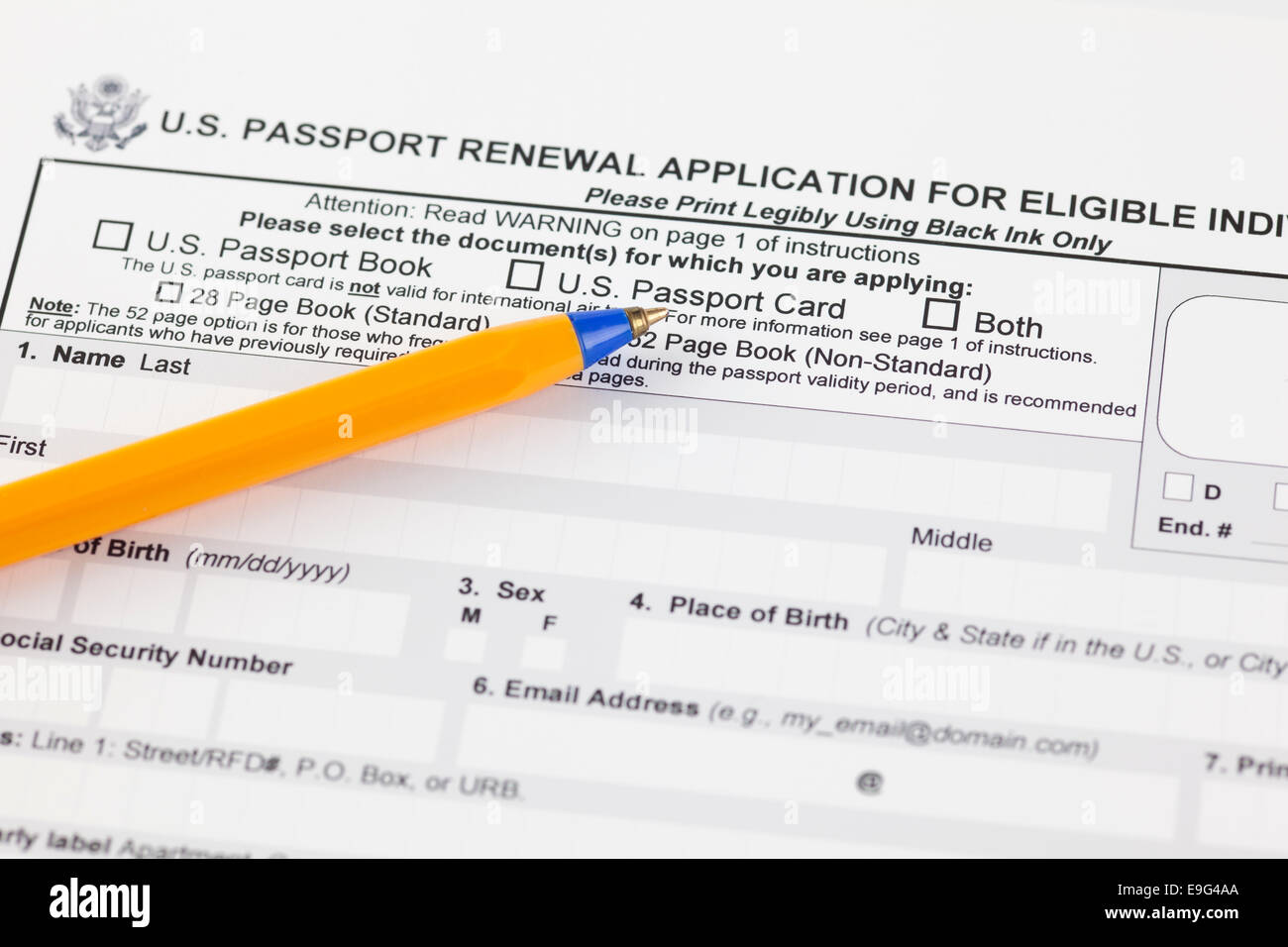 U.S. passport renewal application for eligible individuals with ballpoint pen. Stock Photo