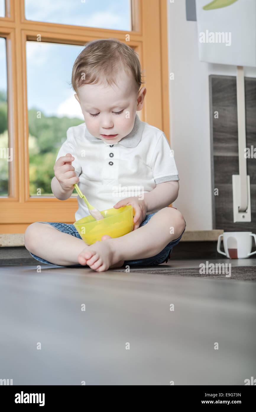 a 1,5 years old boy in the kitchen Stock Photo