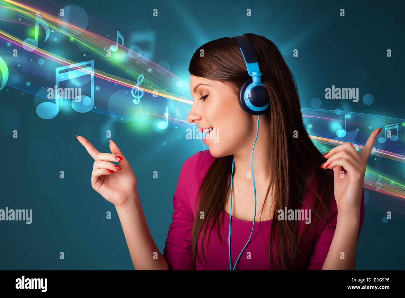 Young woman listening to music with headphones Stock Photo - Alamy