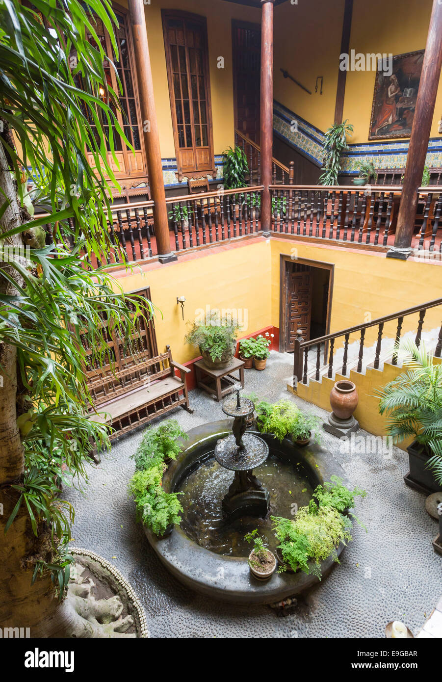 Courtyard with gallery, ornamental fountain and staircase in the historic colonial house, Casa Solariega de Aliaga, Lima, Peru, home of Francisco Piza Stock Photo