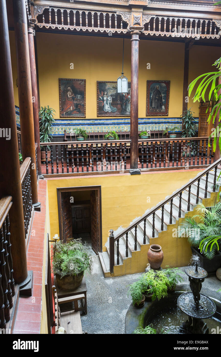 Courtyard with gallery, ornamental fountain and staircase in historic colonial house, Casa Solariega de Aliaga, Lima, Peru, home of Francisco Pizarro Stock Photo