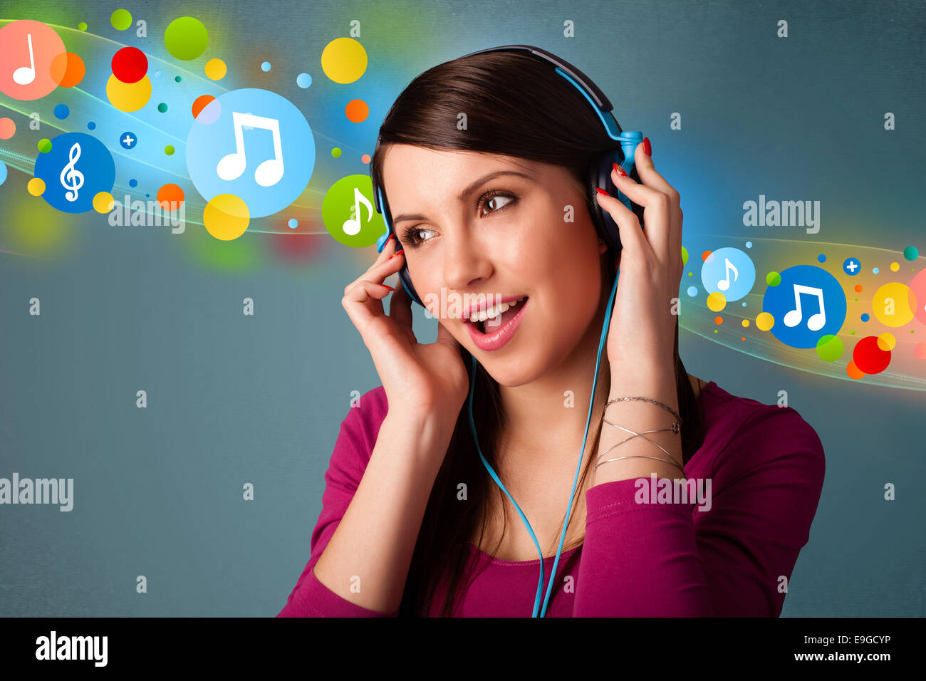 Young woman listening to music with headphones Stock Photo - Alamy