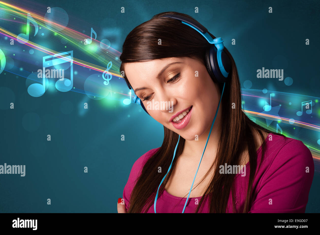 Young woman listening to music with headphones Stock Photo - Alamy