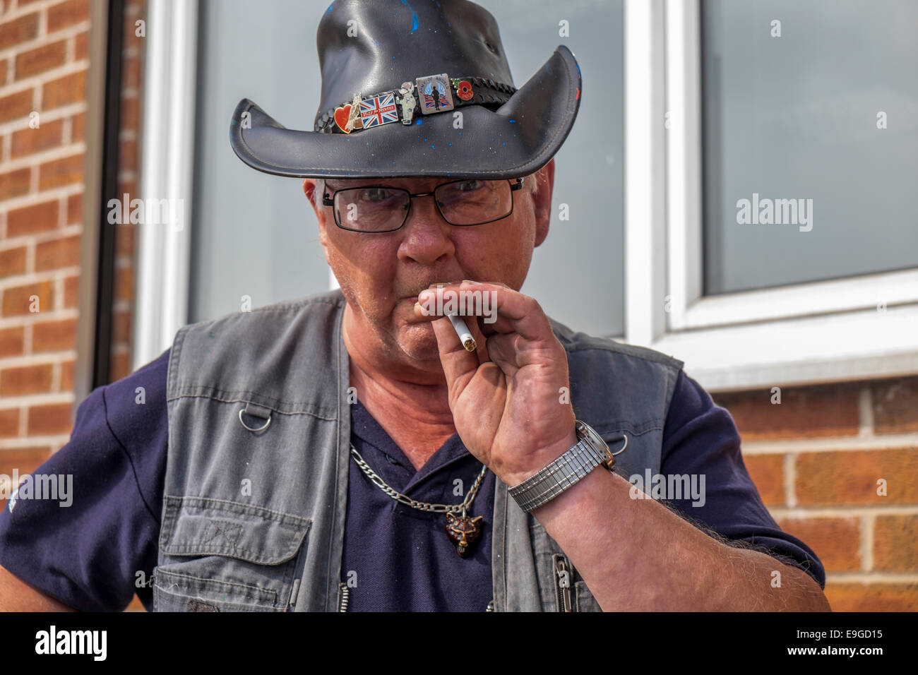 An elderly man in a leather cowboy hat 