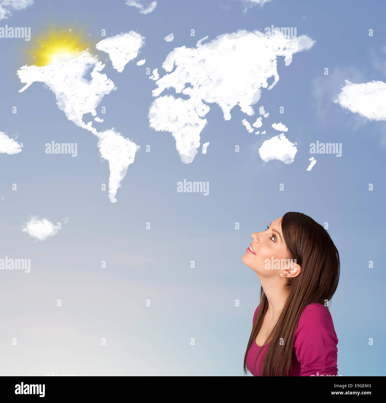 Young girl looking at world clouds and sun on blue sky Stock Photo - Alamy