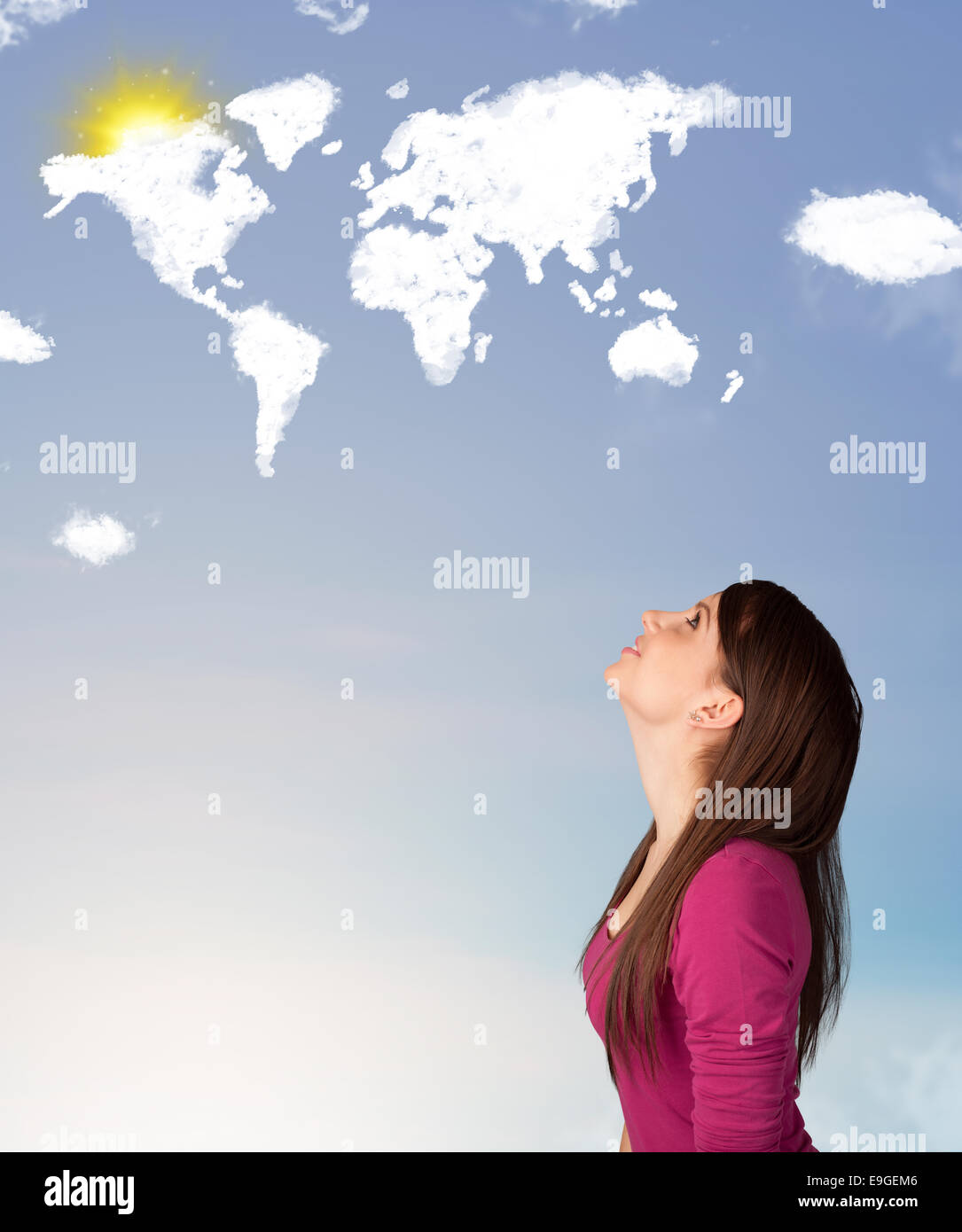 Young girl looking at world clouds and sun on blue sky Stock Photo - Alamy