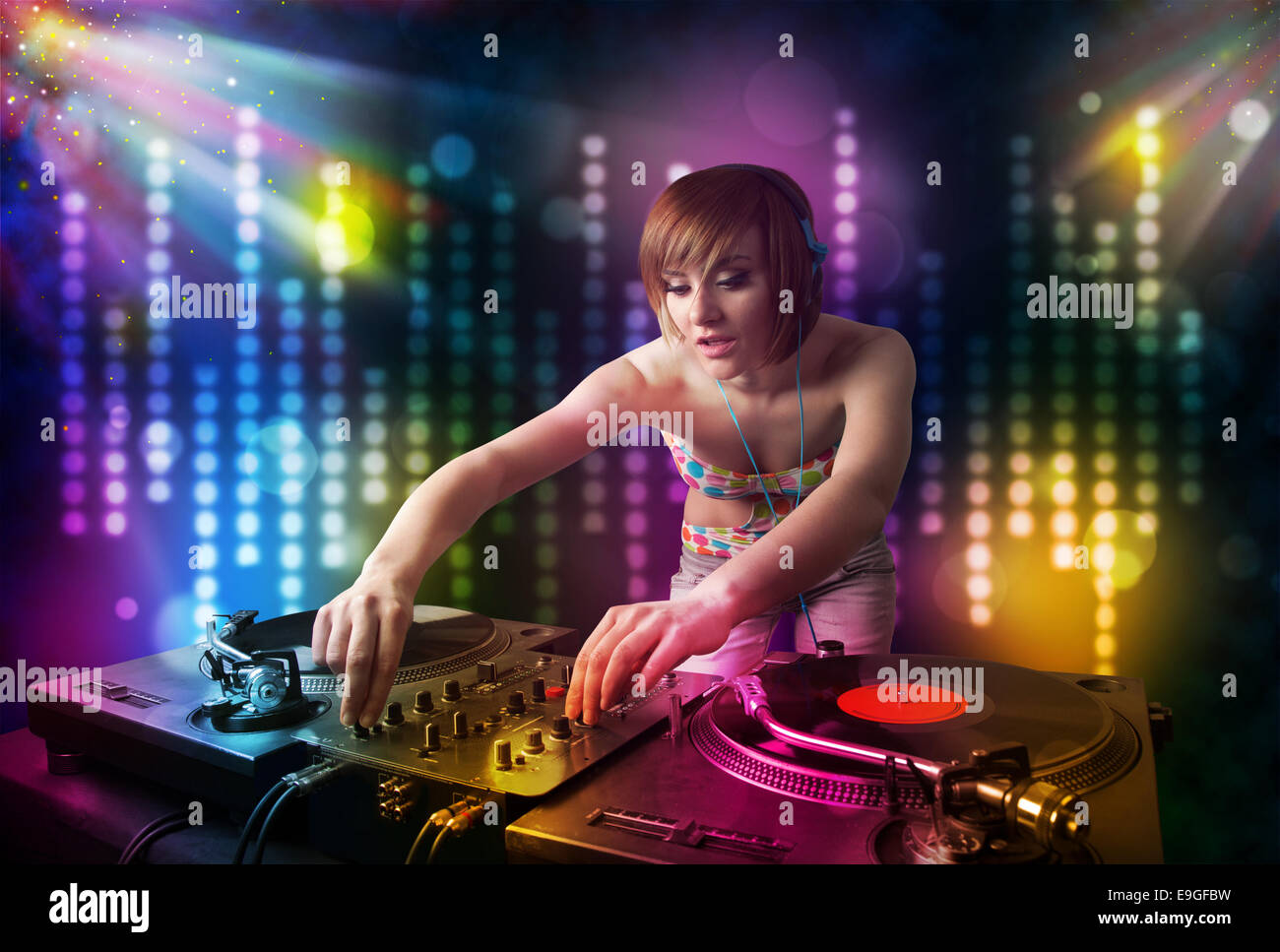 Dj girl playing songs in a disco with light show Stock Photo - Alamy