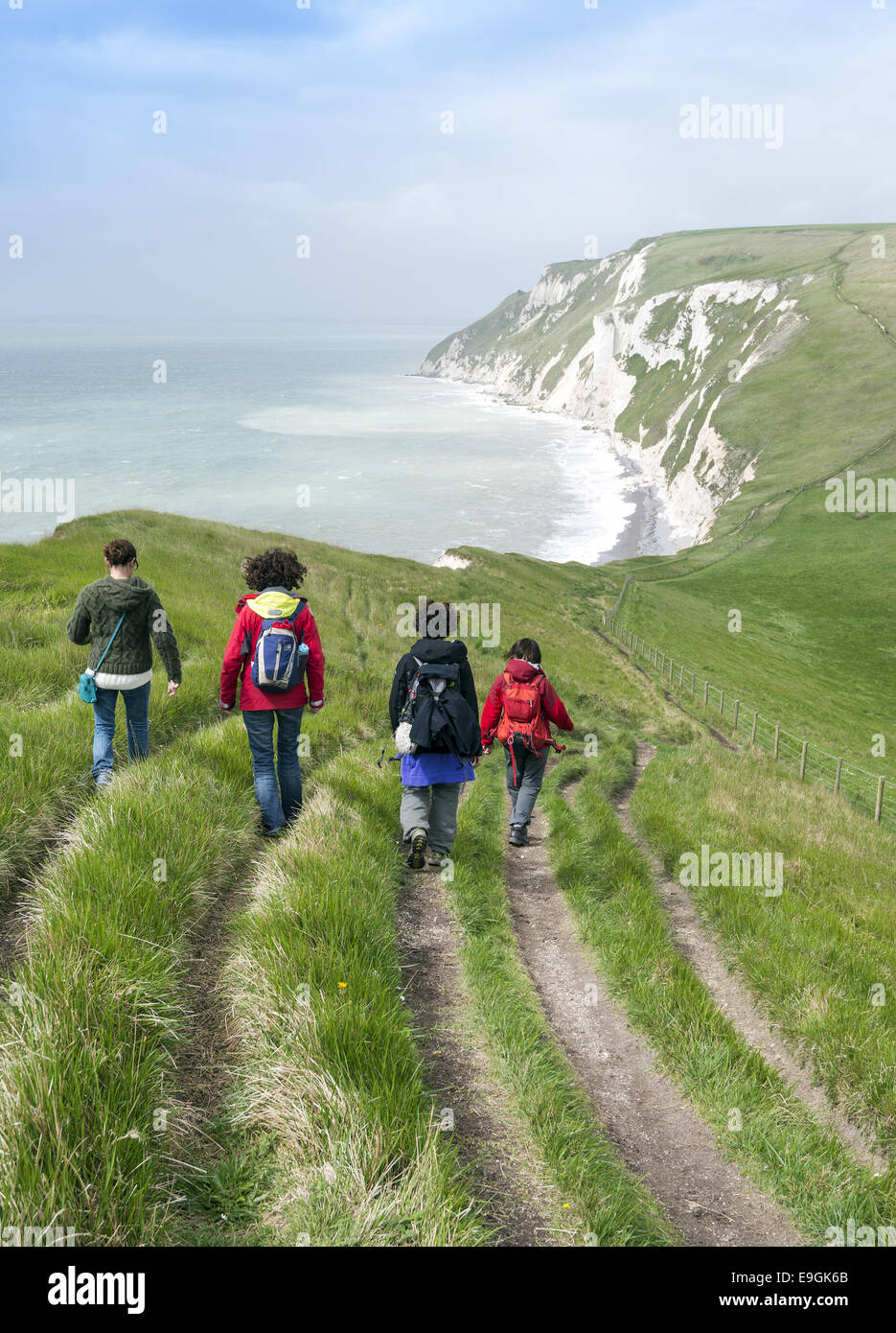 Group of women walking the South West Coastal Path between Durdle Door and White Nothe in Purbeck, Dorset, England, UK Stock Photo