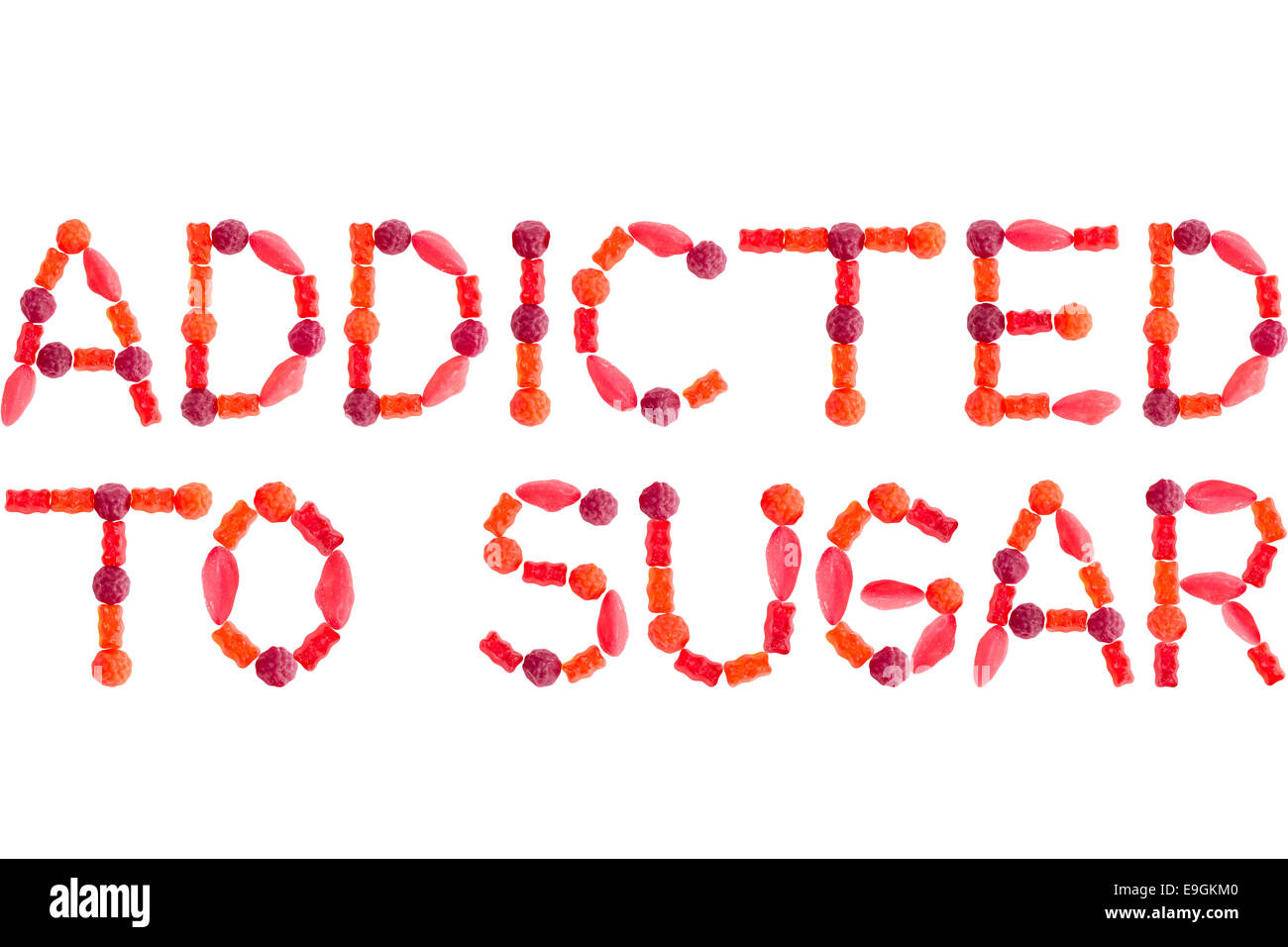Phrase ADDICTED TO SUGAR made of red sugary candies, isolated on white background Stock Photo