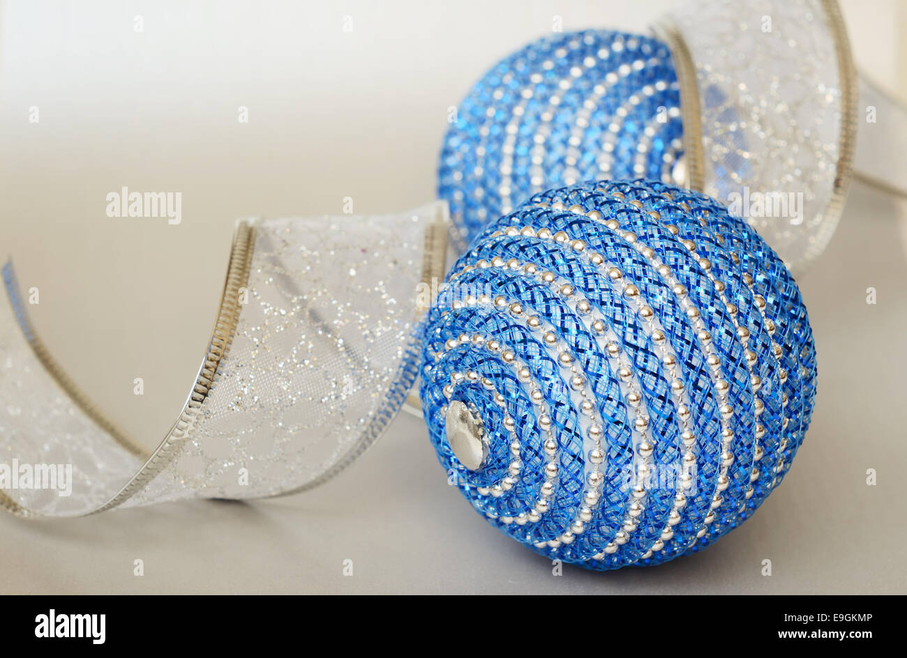 Blue Christmas balls and ribbon on a silver background Stock Photo - Alamy