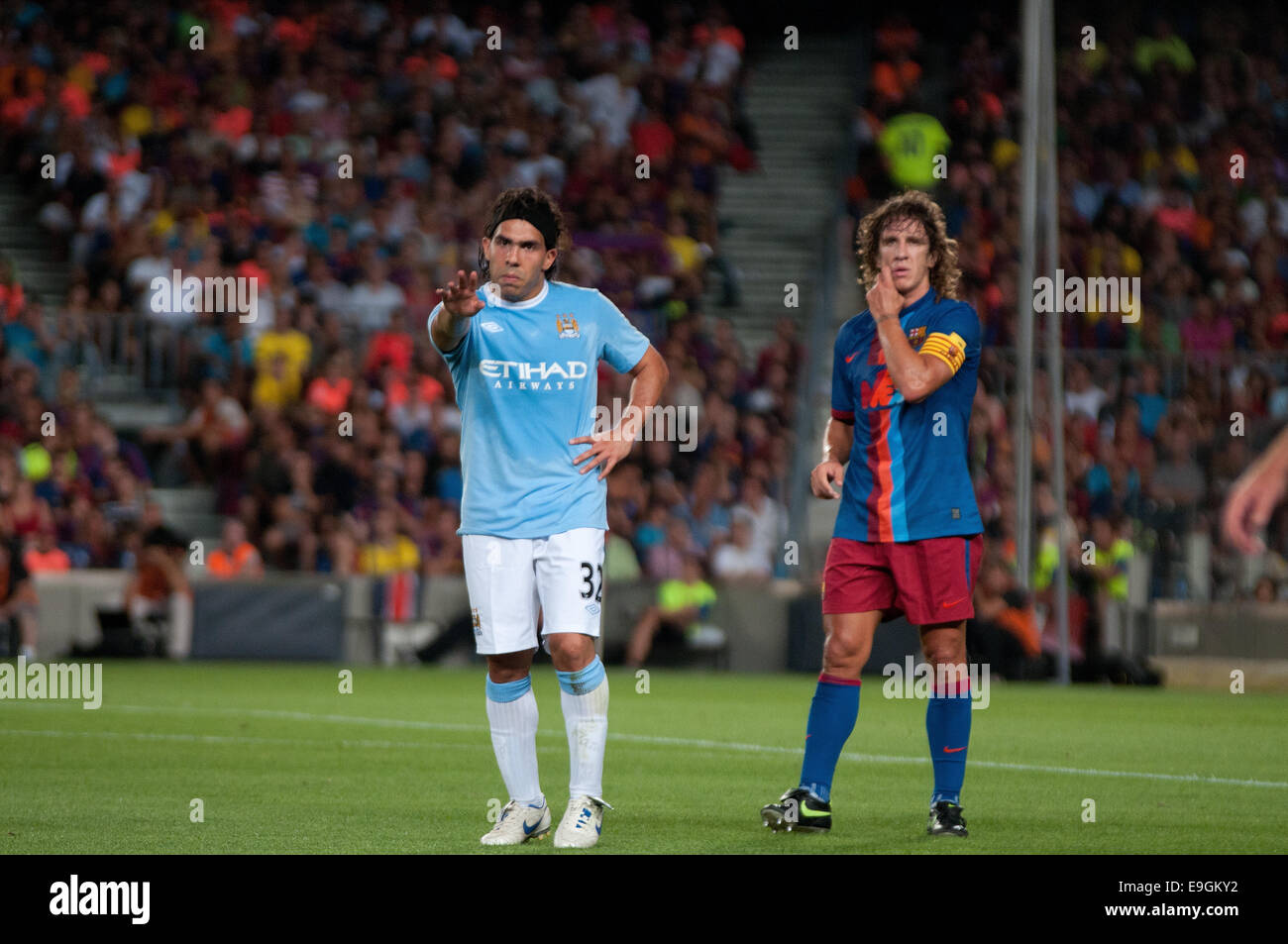 BARCELONA - AUG 19: Carlos Tevez, Manchester City player, plays against Carles Puyol, of F.C Barcelona. Joan Gamper Throphy. Stock Photo