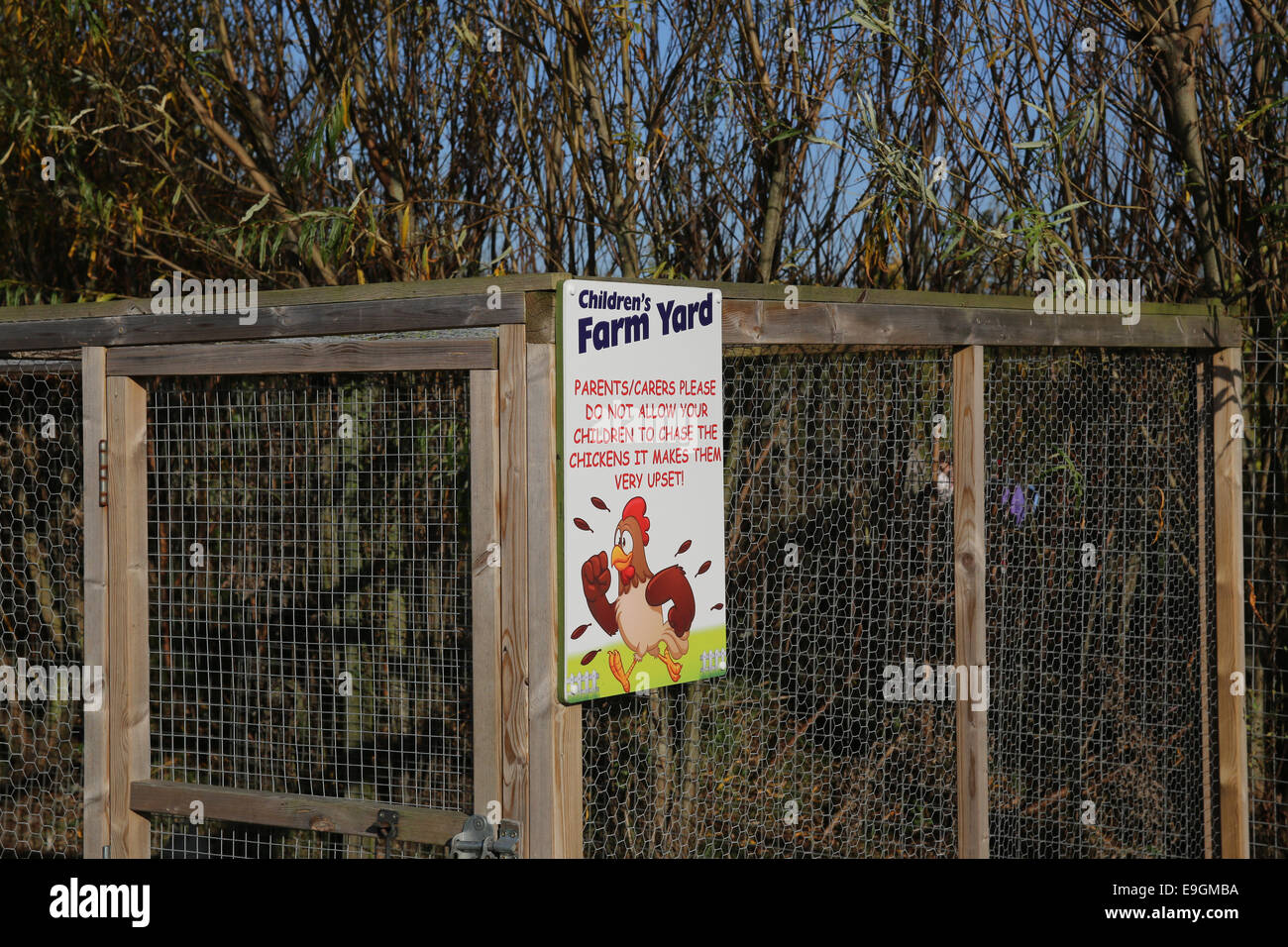 A 'children's farm yard' sign depicting a chicken, at a farm in the UK. Stock Photo