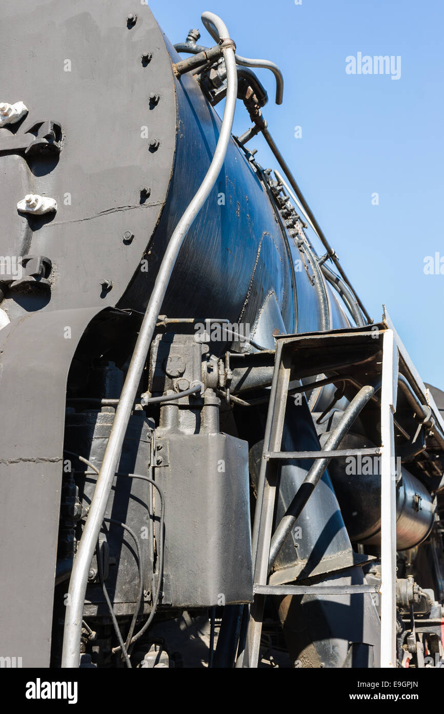 Closeup view of a mechanical equipment around a steam locomotive boiler. Frames, tubes, and cylinders. Stock Photo