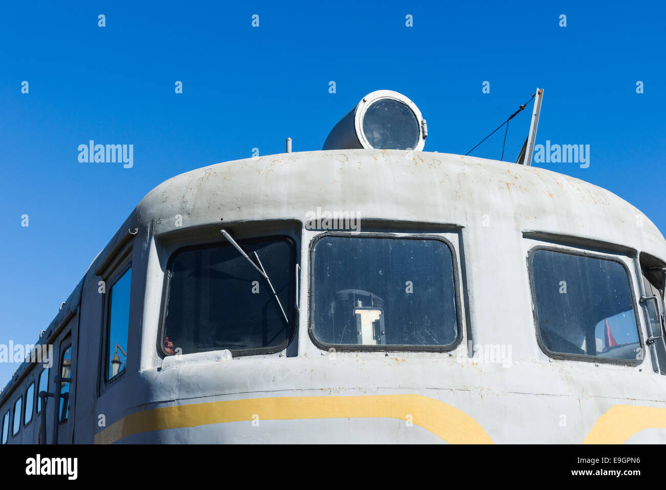 Closeup frontal view of an old diesel locomotive against the background of the clear blue sky Stock Photo