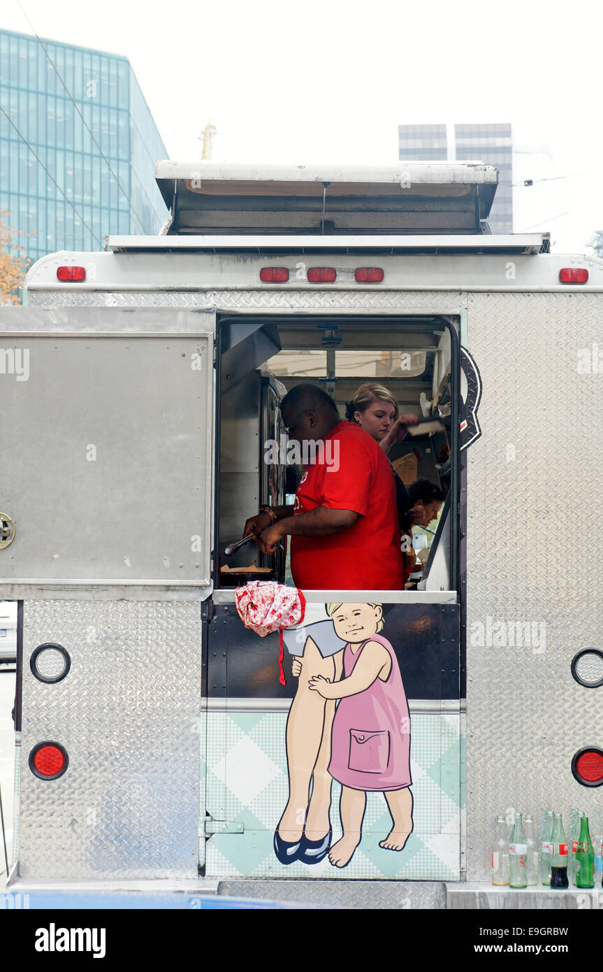 Humorous view of people cooking in a food truck, Vancouver, British