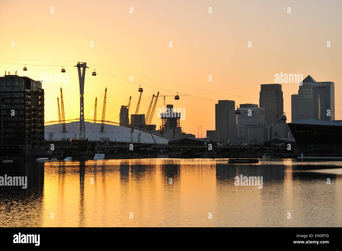 The London O2 Arena and Canary Wharf at dusk, from Royal Victoria Dock Stock Photo