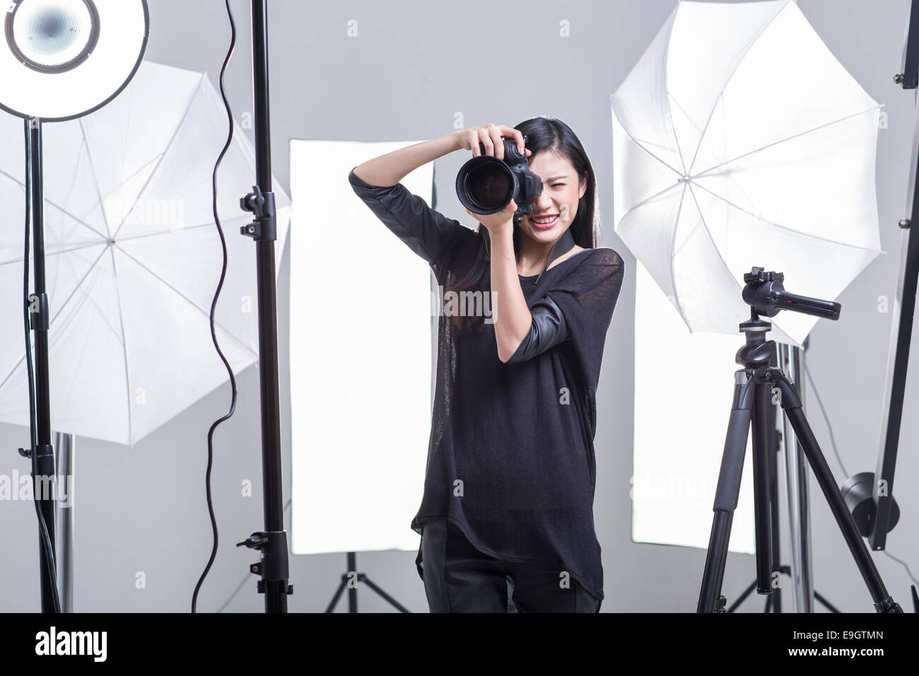 Photographer taking picture in studio Stock Photo Alamy