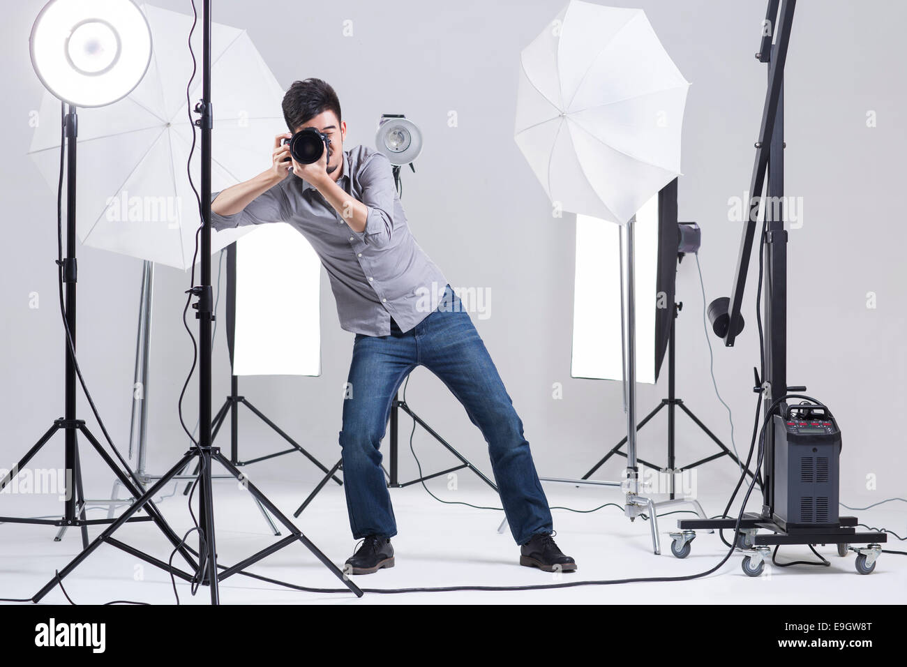 Photographer taking picture in studio Stock Photo Alamy