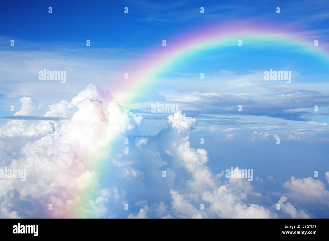 Blue sky with clouds and a rainbow Stock Photo - Alamy