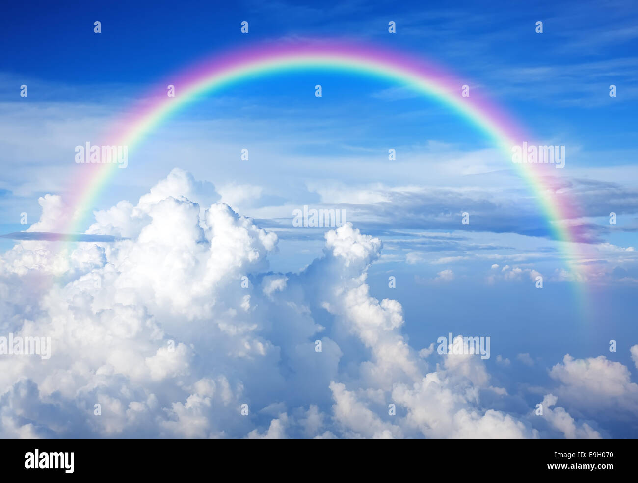Blue sky with clouds and a rainbow Stock Photo - Alamy