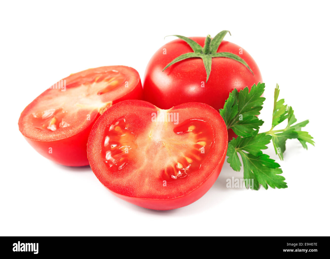 Red tomatoes with parsley leaves on a white background Stock Photo