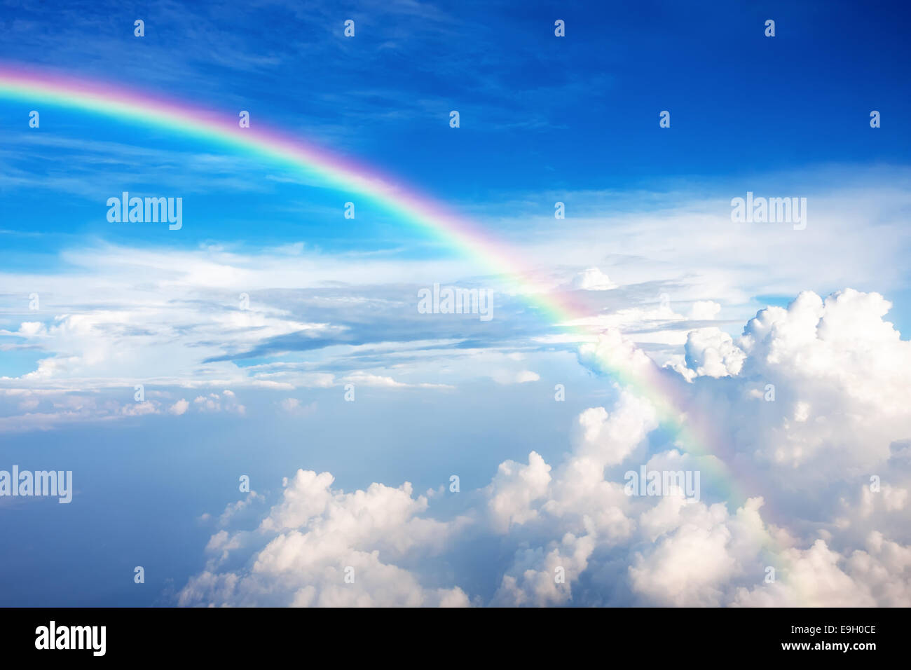 Blue sky with clouds and a rainbow Stock Photo - Alamy