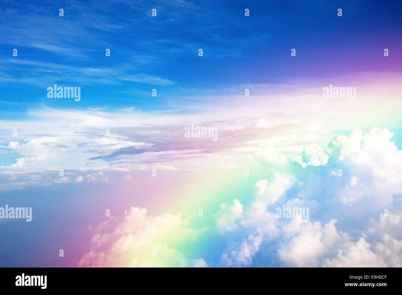 Blue sky with clouds and a rainbow Stock Photo - Alamy