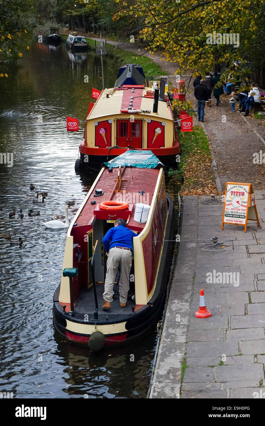 Tourist canal boats on the Leeds Liverpool Canal at Saltaire, Shipley Stock Photo