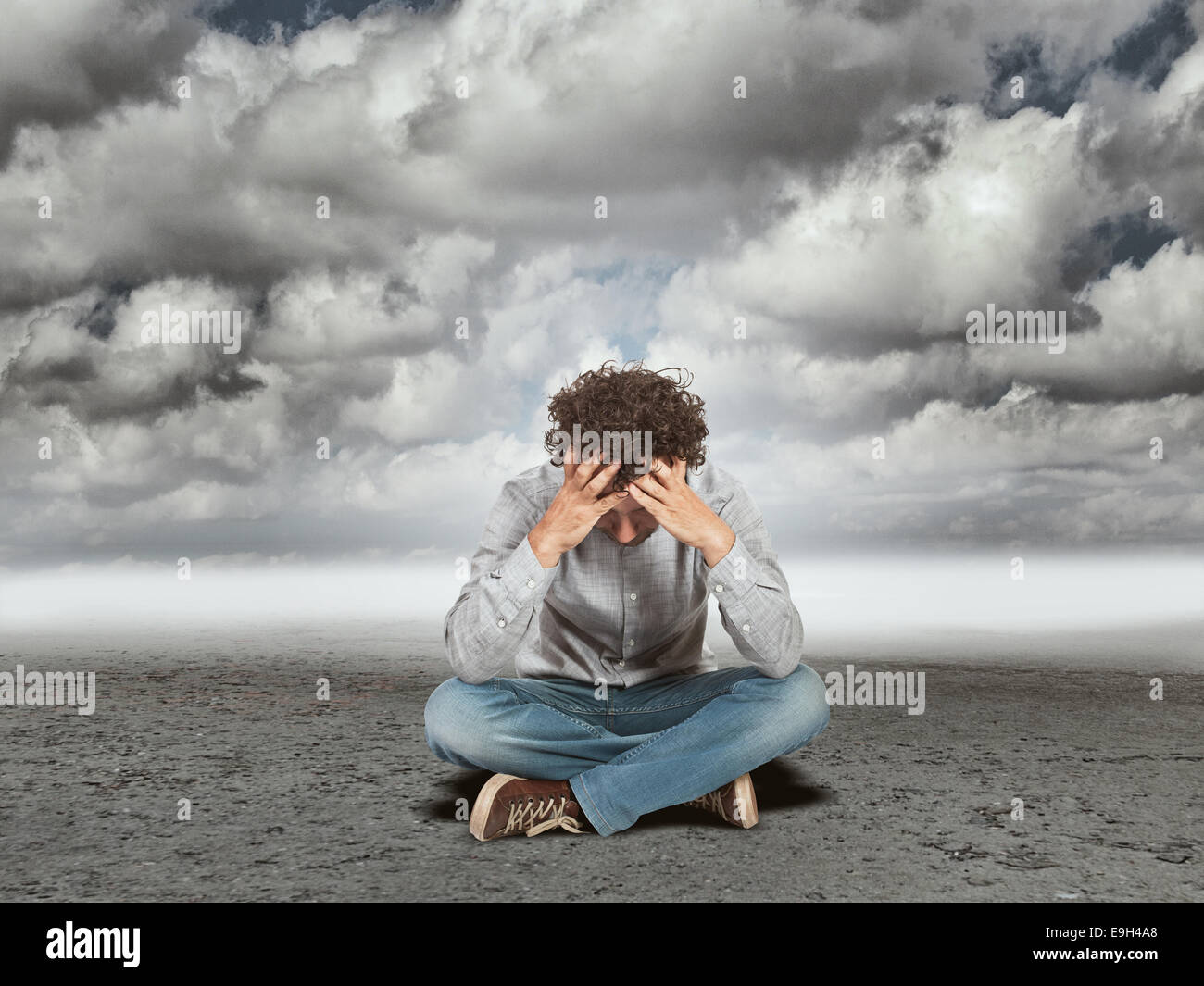 sad man sit in a desert Stock Photo