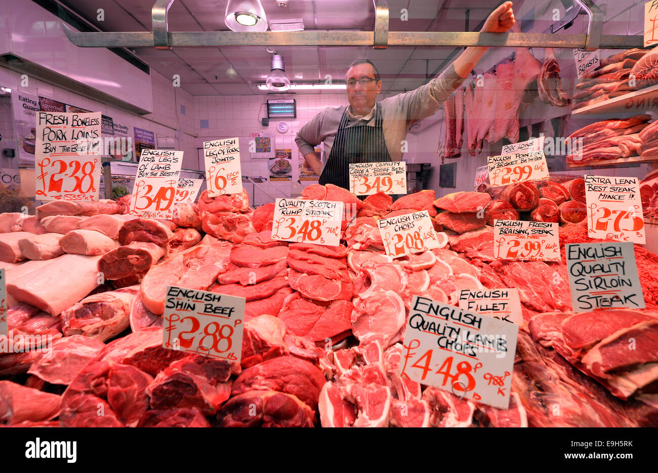 Butcher behind his display, Leeds Kirkgate Market, Leeds, West Yorkshire, England, United Kingdom Stock Photo