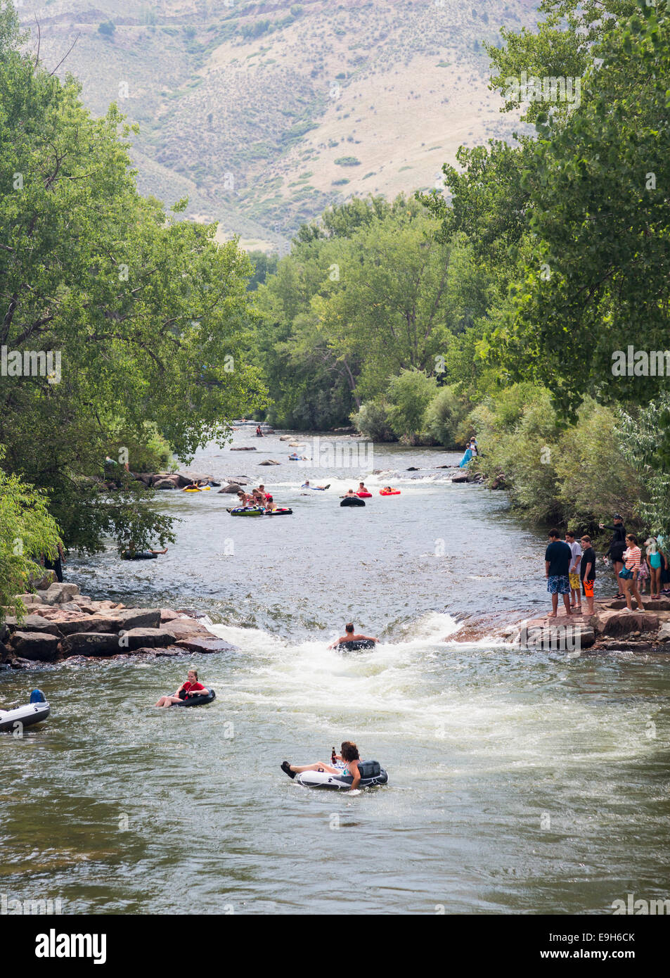 Clear Creek river in Golden, Colorado, USA - with people on the river in tubes and rafts Stock Photo
