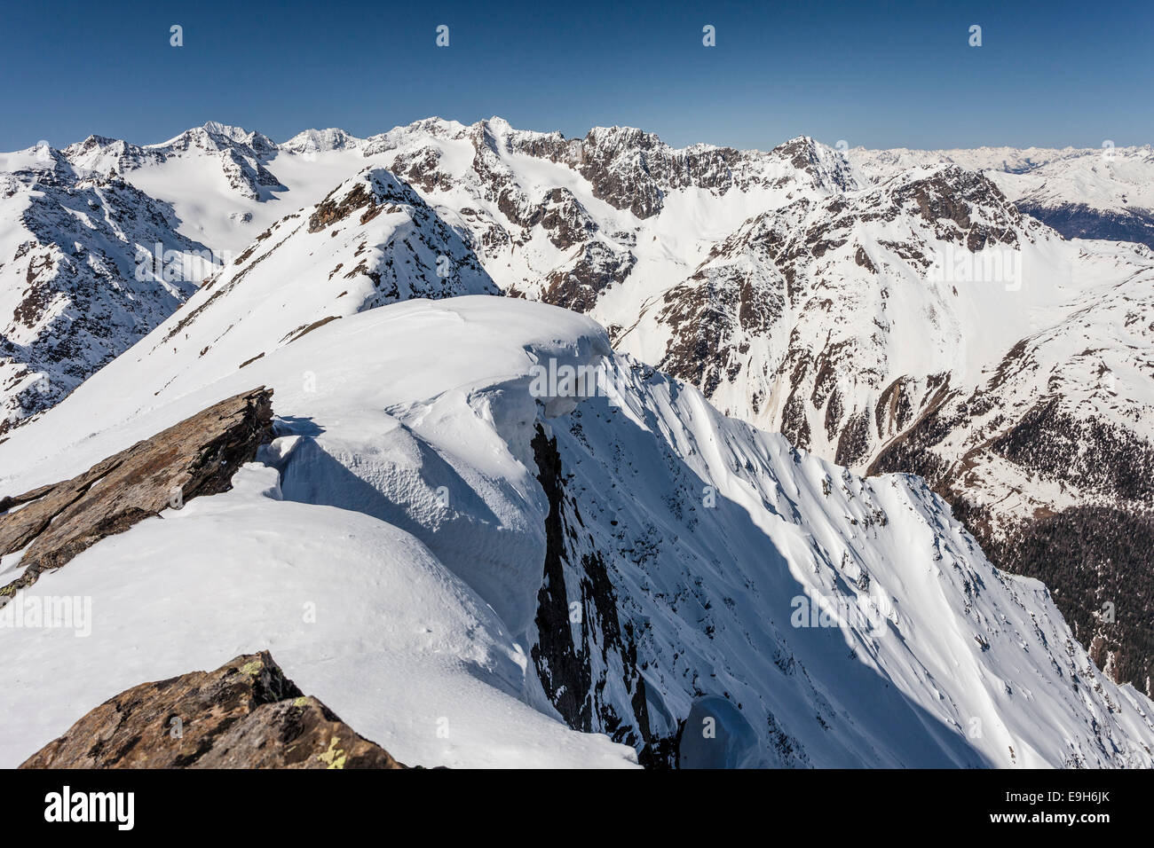 Summit ridge with overhanging snow en route to Mt Laaser Orgelspitze in Val Martello, Martelltal valley Stock Photo