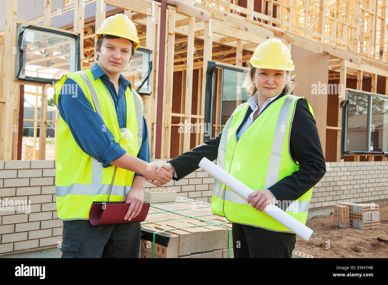 civil engineer and worker shaking hands at the construction site Stock Photo