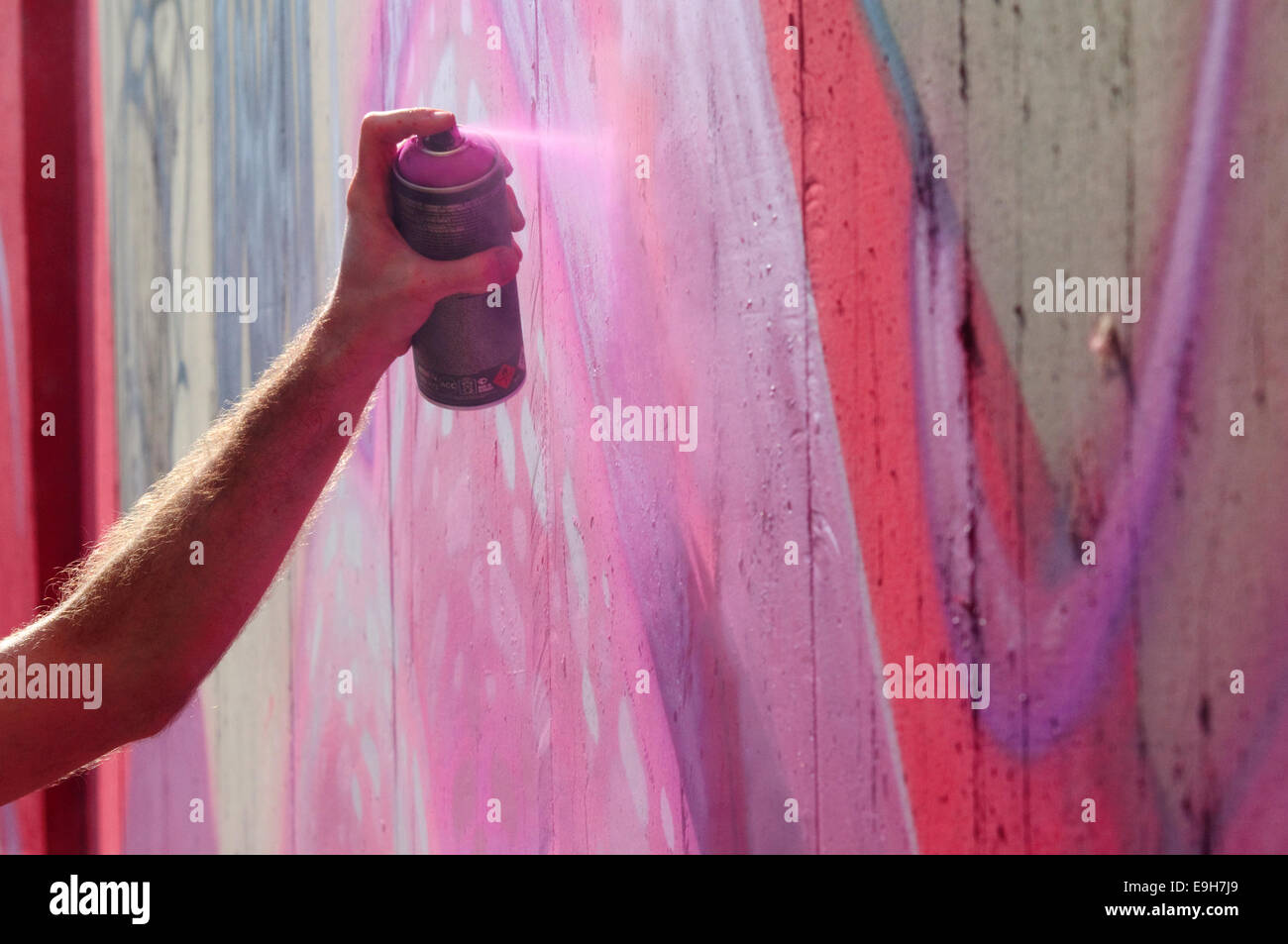 Hand Holding a Spray Can, Graffiti Artist at the Wall Stock Photo - Alamy