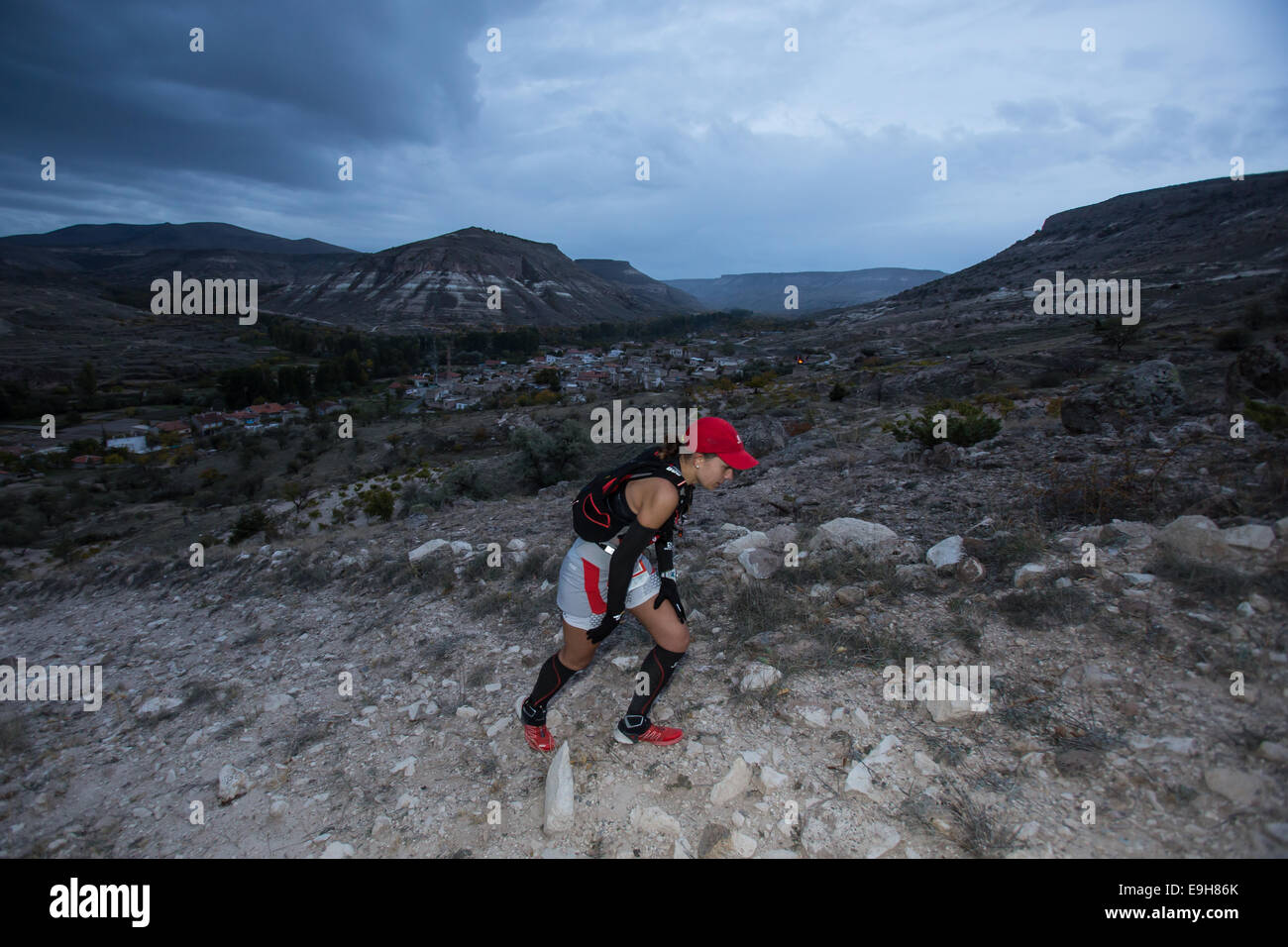 Russian runner Elena Polyakova leads the 110 km race at the "North Face  Cappadocia Ultra Trail", climbing the rugged terrain before a thunderstorm.  © Piero Castellano/Pacific Press/Alamy Live News Stock Photo -