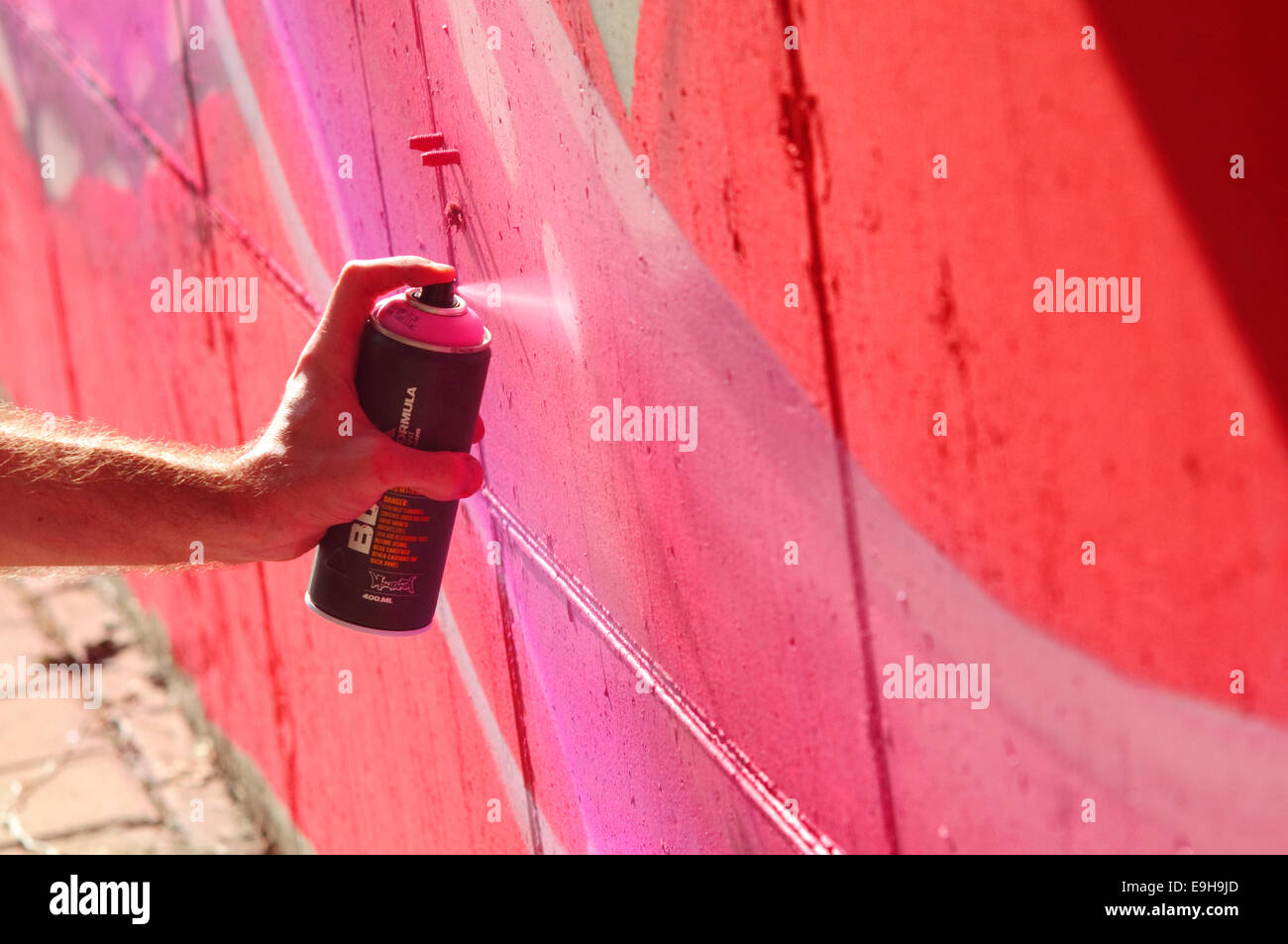Hand Holding a Spray Can, Graffiti Artist at the Wall Stock Photo - Alamy