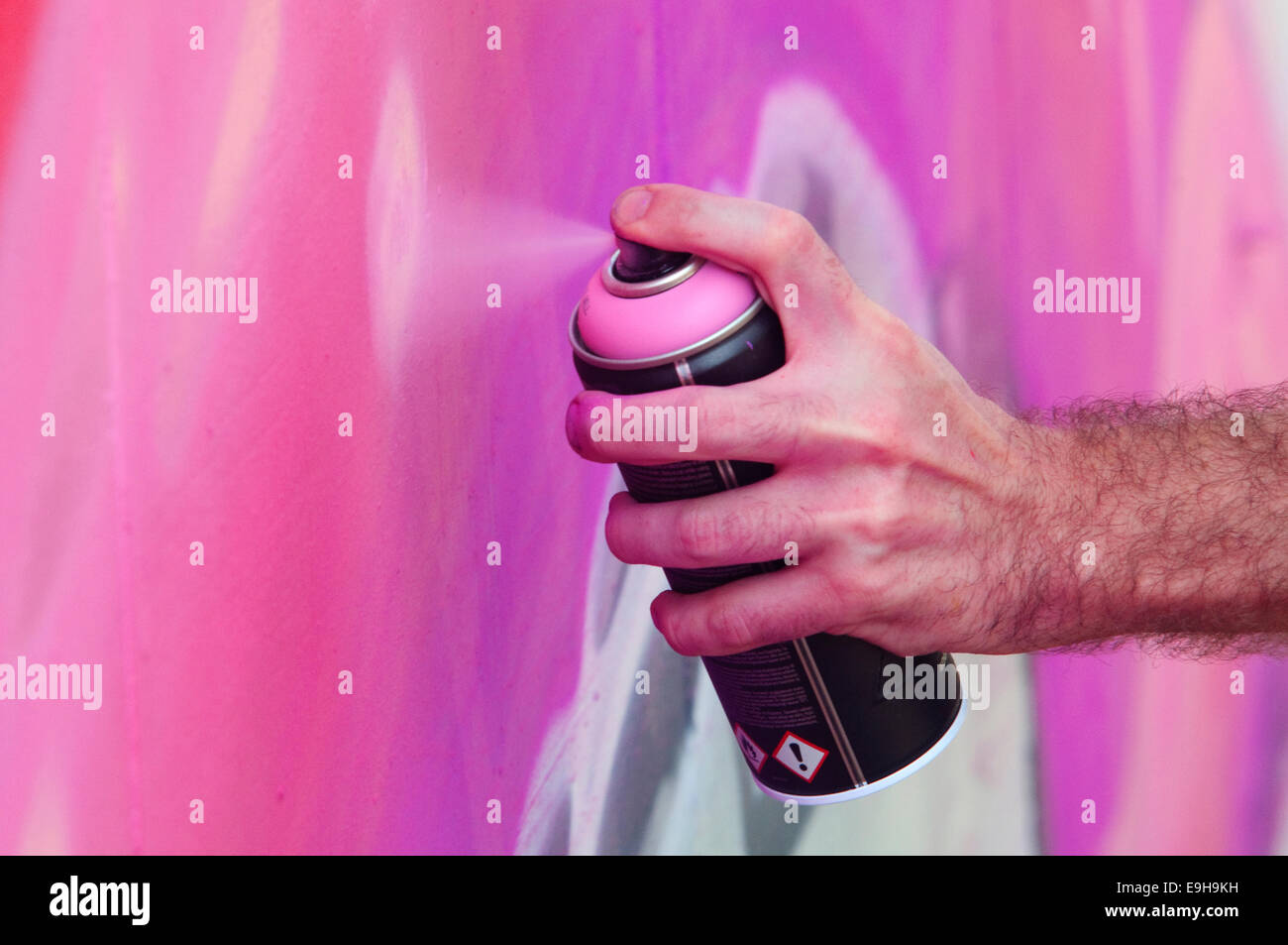 Hand Holding a Spray Can, Graffiti Artist at the Wall Stock Photo - Alamy