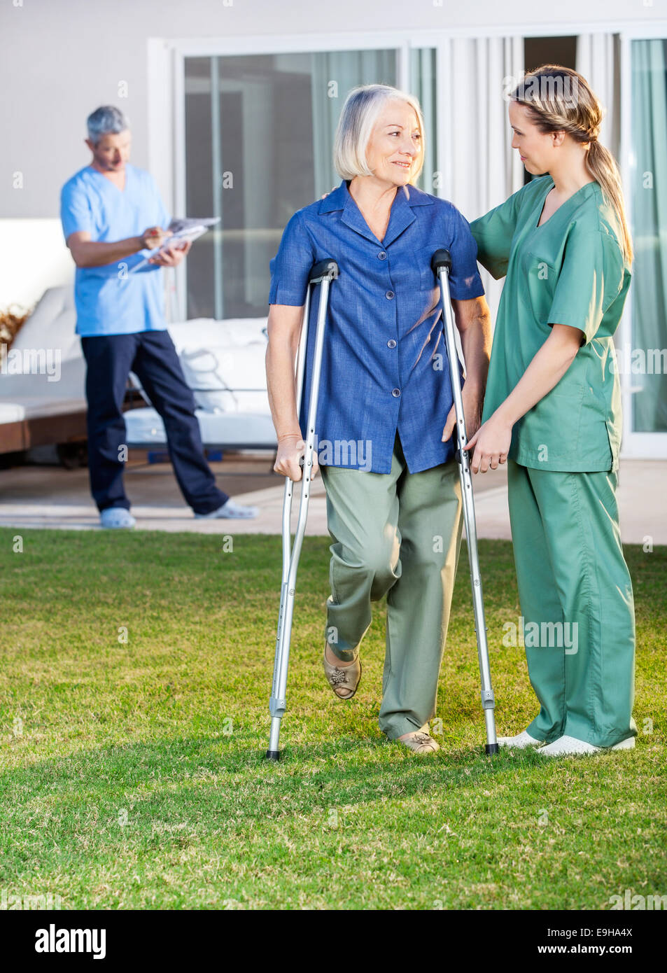Female Nurse Helping Senior Woman To Use Crutches Stock Photo Alamy