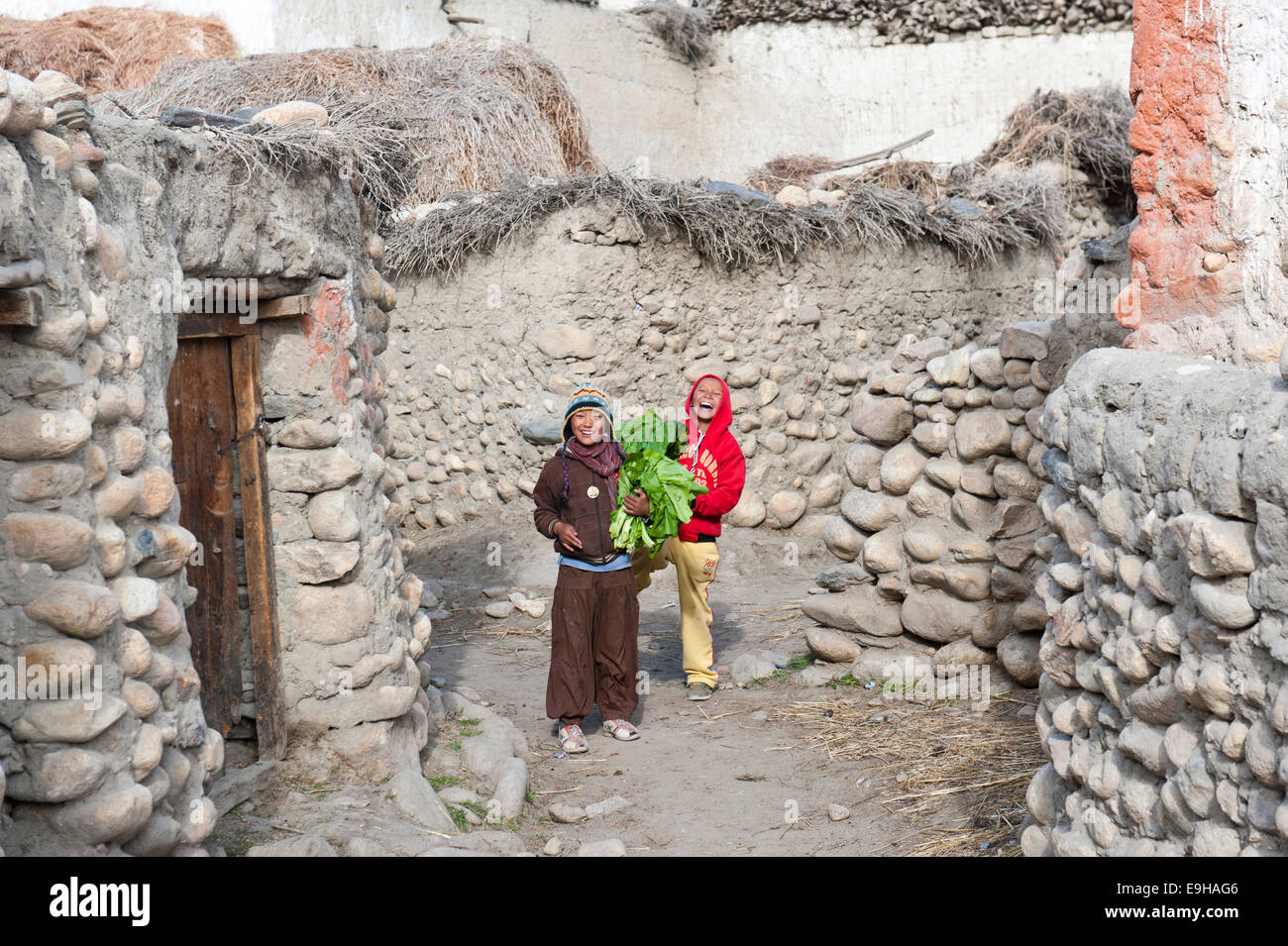 Cheerful children in a village between old walls, ethnic group of Lopa, Charang, Lo or Mustang, Nepal Stock Photo