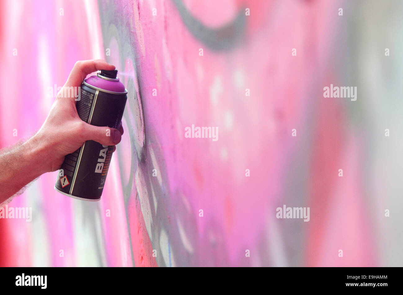 Hand Holding a Spray Can, Graffiti Artist at the Wall Stock Photo - Alamy