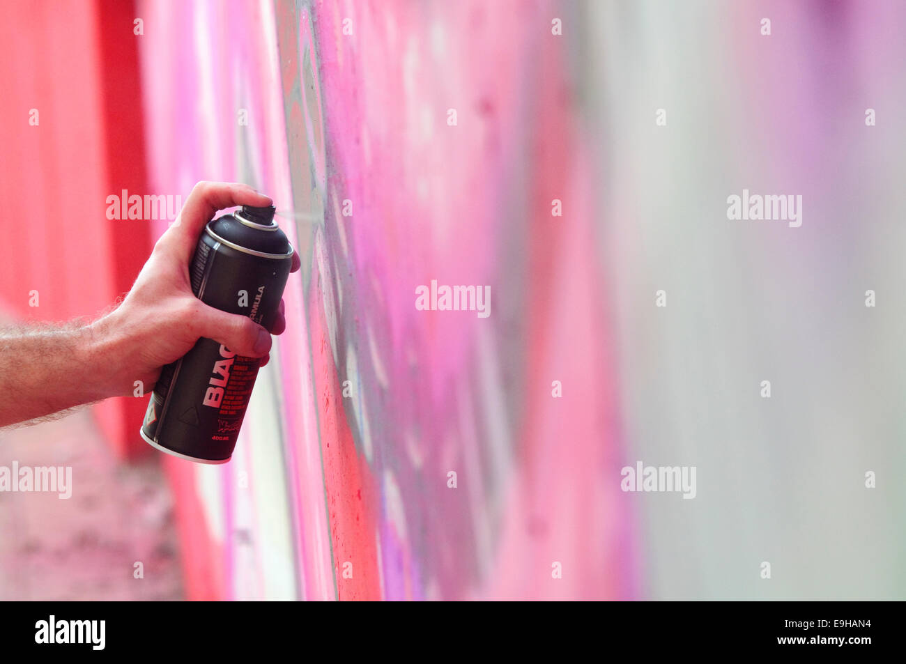 Hand Holding a Spray Can, Graffiti Artist at the Wall Stock Photo - Alamy