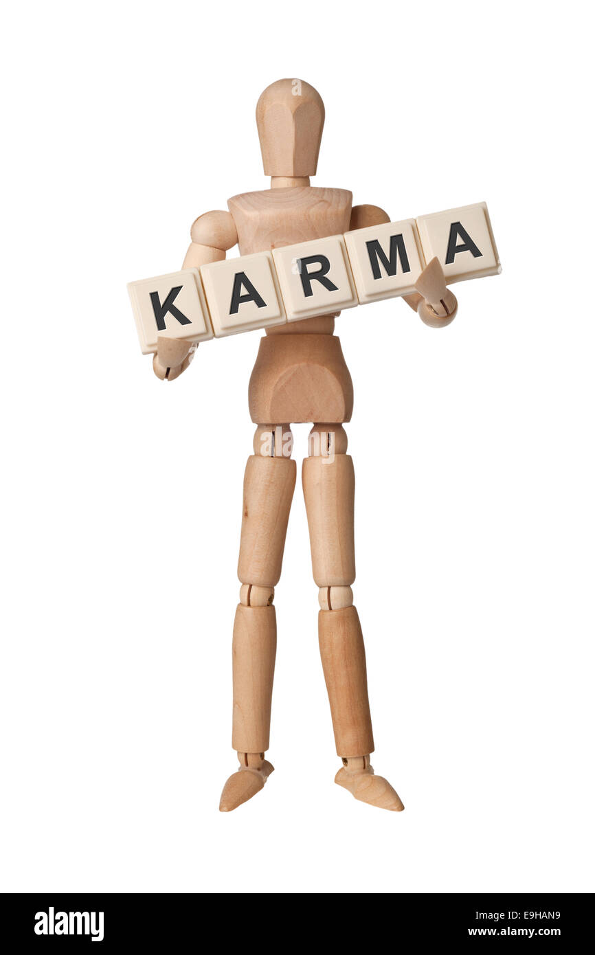 Wooden figurine with the word KARMA isolated on white background Stock Photo