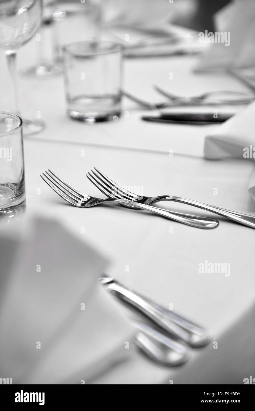Detail with two forks on elegant dinner table in a restaurant Stock Photo