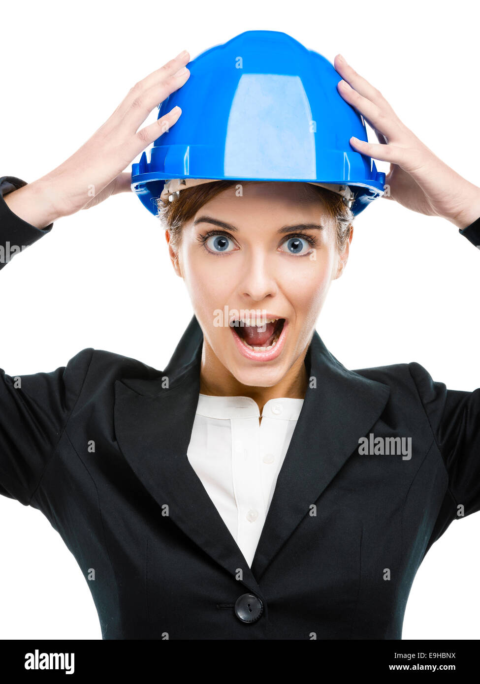Fuuny portrait of young female engineer with hands holding a blue helmet Stock Photo