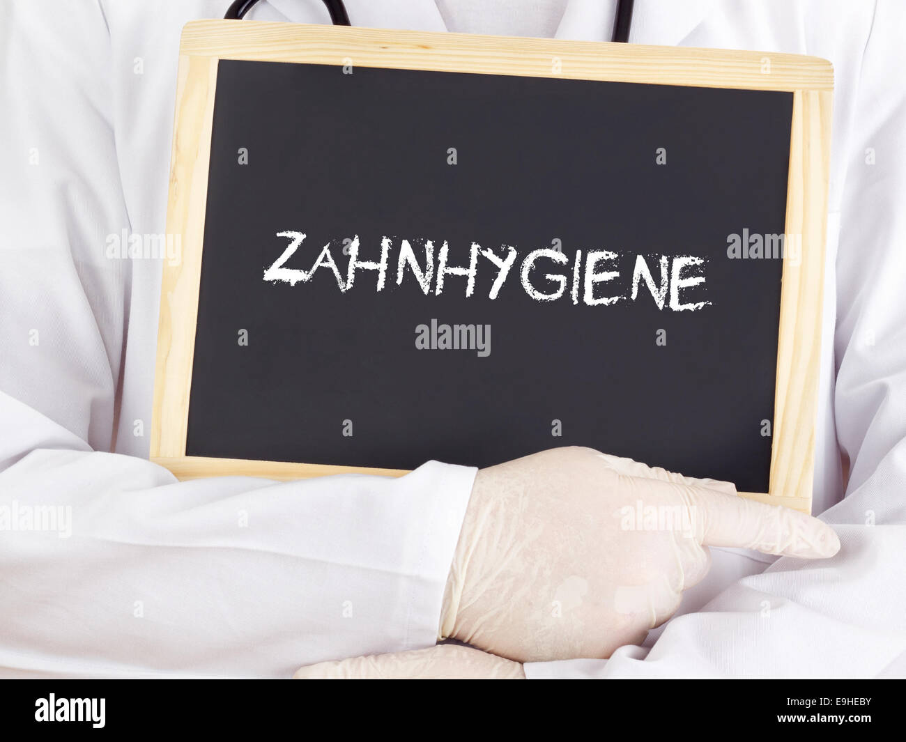 Doctor shows information dental hygiene in german Stock Photo Alamy