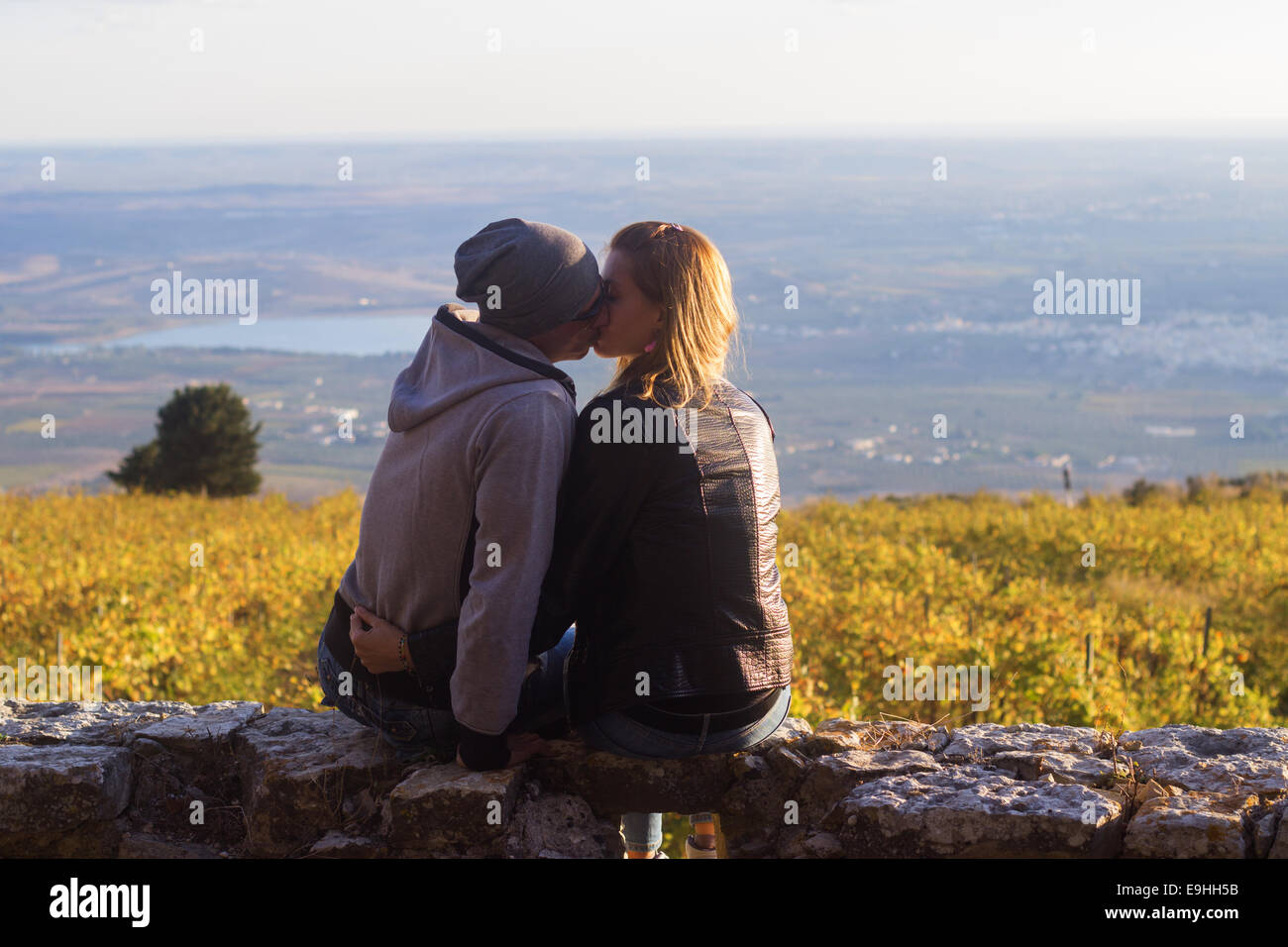 couple relationship young people lifestyle countryside sunset sitting 'copy space' Stock Photo
