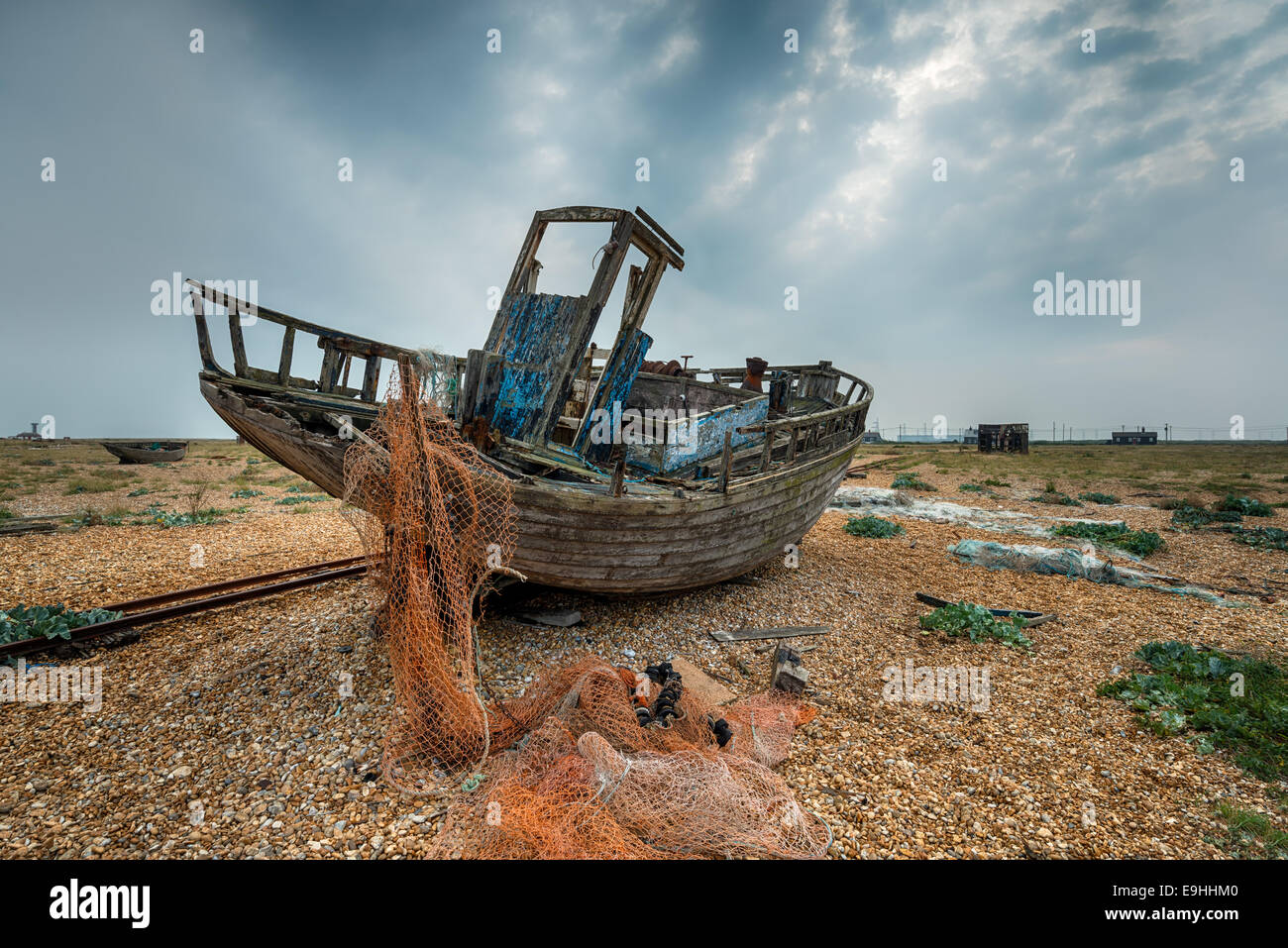 Old abandoned fishing boat and nets on shingle at Dungeness in Kent ...
