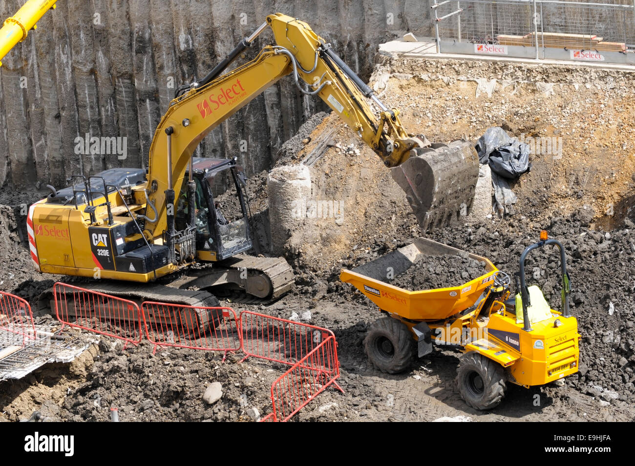A Caterpillar hydraulic excavator filling a Thwaites Alldrive 6 tonne front tipper truck with