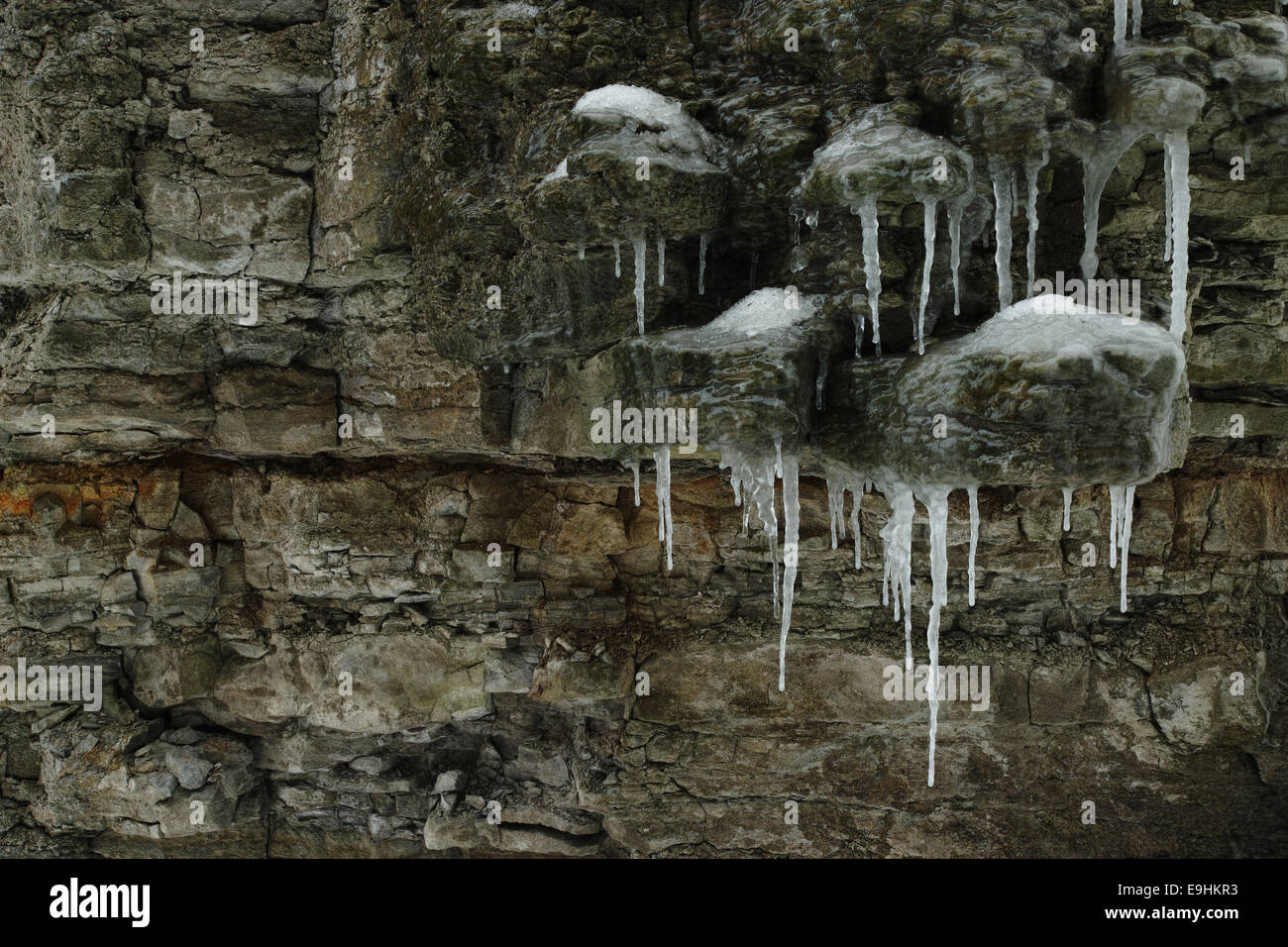 Icicles form from water seepage through sedimentary rock. Stock Photo